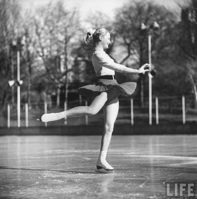 1955. Olympic skater Carol Heiss performing on ice outdoors at Wollman Memorial Rink in Central Park.